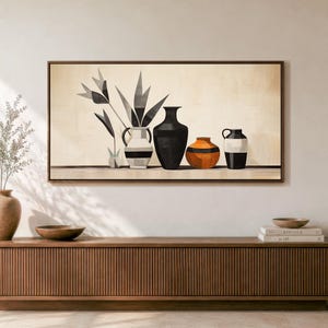 May include: A rectangular framed wall art print featuring a still life composition of four vases and stylized foliage. The artwork displays a white vase with black stripes, a tall black vase, an orange rounded vase, and a black and white vase.