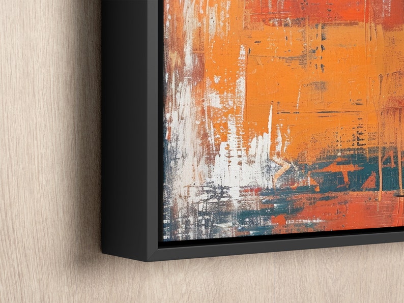 an orange and blue painting hanging on a wall