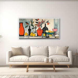 a living room with a white couch and a painting on the wall