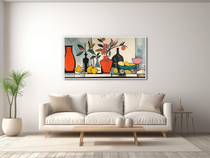 a living room with a white couch and a painting on the wall