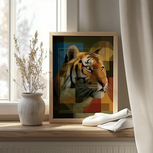 May include: A framed art print featuring a geometric tiger portrait. The artwork uses a mosaic style with orange, brown, yellow, blue, and green shapes. The print is displayed on a wooden windowsill with a vase and dried plants.