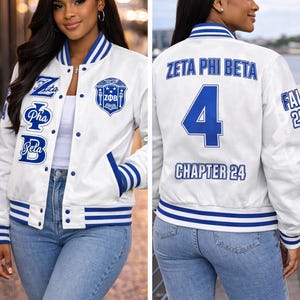May include: A white varsity jacket with blue striped ribbed trim on the collar, cuffs, and hem. The front features blue embroidered text reading Zeta Phi Beta and a crest. The back displays the text Zeta Phi Beta, the number 4, and Chapter 24.