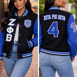 May include: A black and blue varsity jacket featuring the Greek letters NΦB on the front right chest, a circular crest on the front left, and the text ZETA PHI BETA with the number 4 on the back. The jacket has striped ribbed trim.