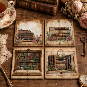 May include: A set of four square coasters featuring vintage-style illustrations of stacked books, open books, and bookshelves, accented with floral motifs and ornate decorative borders in shades of brown, cream, and muted colors on a wooden surface.