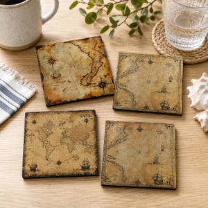 May include: A set of four square coasters featuring vintage-style nautical map illustrations. Each coaster displays aged parchment-colored backgrounds with detailed cartography, compass roses, and illustrations of sailing ships in dark ink.