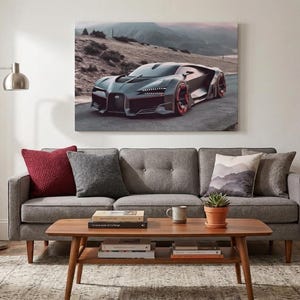 May include: A framed canvas print of a sleek, dark gray sports car with red accents, set against a mountainous landscape. The artwork hangs above a gray sofa with decorative pillows, a wooden coffee table, and a potted plant.