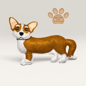 May include: A felt corgi dog toy in shades of brown, white, and tan. The toy has large ears, a black nose, and a curled tail. The text "DIGITAL PDF PATTERN" is above a paw print graphic.