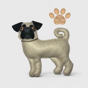 May include: A handmade felt pug dog with black ears and muzzle, and brown eyes. The dog is light tan in color and has a curled tail. Above the dog is a paw print graphic with the text "DIGITAL PDF PATTERN".