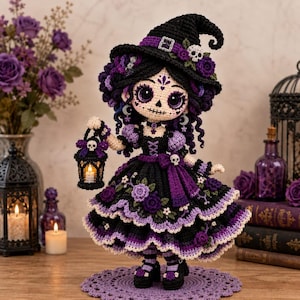 May include: A crocheted doll dressed as a witch in a black and purple gown with floral accents, a pointed hat with a skull, and dark makeup. The doll holds a small black lantern with a glowing light, standing on a matching purple crochet mat.
