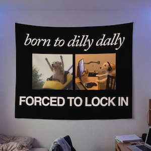 May include: Black tapestry with the text "born to dilly dally" above two images of a dog. The top image shows a dog on a roller coaster. The bottom image shows a dog at a computer with the text "FORCED TO LOCK IN".