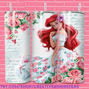 May include: A stainless steel tumbler featuring a princess with long red hair, a white dress, and a floral design. The tumbler is adorned with pink roses and script. A straw is included. The text "PNG" is visible.