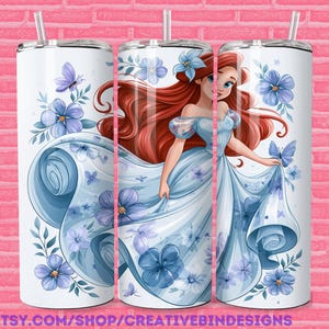 May include: White tumbler featuring a princess in a light blue gown with red hair, surrounded by blue flowers and butterflies. The tumbler has a silver lid and straw. The text "PNG" and "ETSY.COM/SHOP/CREATIVEBINDESIGNS" are visible.