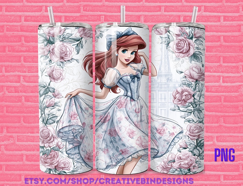 May include: A set of three stainless steel tumblers with a floral design and a cartoon illustration of a princess. The princess is wearing a blue dress and has red hair. The tumblers have a white background and are decorated with pink roses and green leaves. The tumblers have a straw.