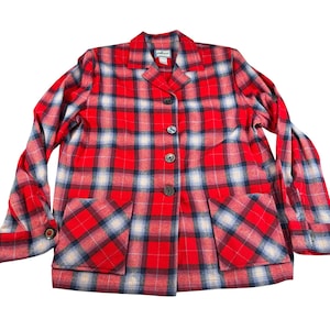 May include: A white ceramic mug with a black handle and the text "But First, Coffee" in a black, handwritten-style font. The mug is on a white surface.