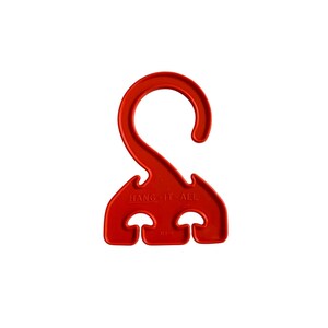 May include: A bright red plastic utility hook featuring a large curved top for hanging and three smaller integrated hooks at the base. The text HANG-IT-ALL is embossed on the front surface, along with the small molded text 314-0.