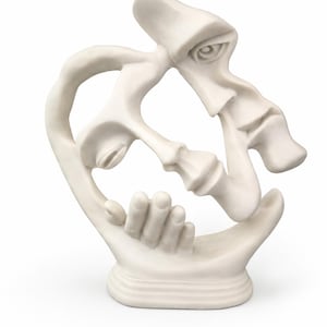 May include: A matte white sculpture featuring two abstract faces intertwined with a hand resting near the chin. The piece is crafted from a solid, smooth material and stands on a circular base, showcasing fluid, organic curves and interconnected forms.