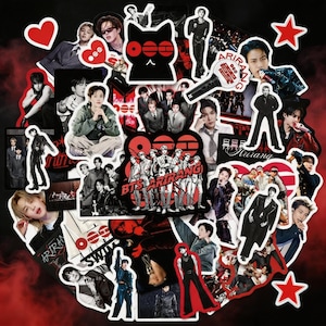 May include: A collection of stickers featuring images of a K-pop group, with red and black accents. The stickers include portraits of the band members, along with the band's name and other graphics. The stickers are arranged in a circular pattern.