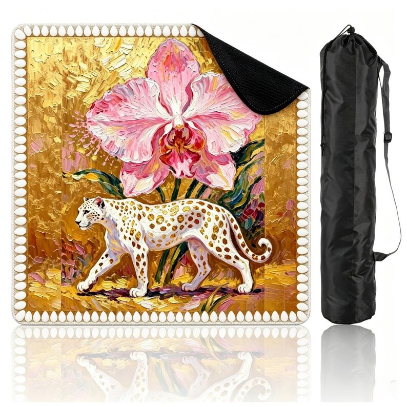 May include: A square mat featuring an impasto-style painting of a white leopard with gold spots walking beneath a large pink orchid against a textured gold background, bordered by a white scalloped edge, accompanied by a black cylindrical carrying bag.