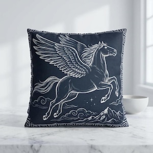 May include: A square navy blue throw pillow featuring a white illustration of a winged horse, Pegasus, in mid-flight. The design includes clouds, mountains, and stars. The pillow has a decorative border.
