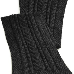 May include: A pair of charcoal gray knitted leg warmers with a cable knit pattern.