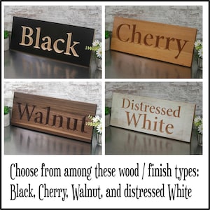 May include: Four wooden signs with different wood finishes: black, cherry, walnut, and distressed white. The signs have the wood finish name engraved on them. Choose from among these wood / finish types: Black, Cherry, Walnut, and distressed White