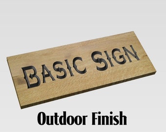 May include: A wooden sign with the text "BASIC SIGN" carved into it. The sign has an outdoor finish.
