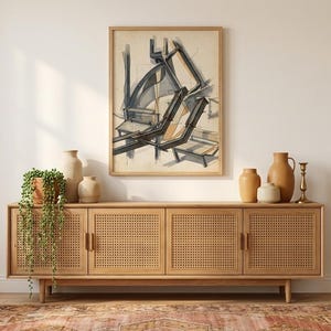 May include: A light wood cabinet with woven door panels, holding various ceramic vases and a potted plant. An abstract art print hangs above the cabinet. A patterned rug is on the floor.