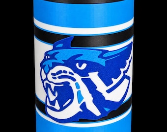 May include: A cylindrical beverage cooler featuring a black top rim and a body with horizontal stripes in bright blue, white, and black. A raised, blue and white graphic of a snarling wildcat head is centered on the front of the cooler.