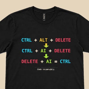 May include: A black short-sleeved t-shirt featuring a graphic print with the text CTRL + ALT + DELETE, followed by CTRL + AI + DELETE, and finally DELETE + AI = CTRL, with the text Code responsibly. below. The text uses blue, yellow, red, and green colors.