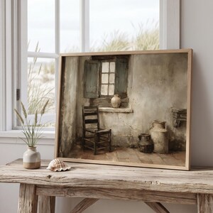 May include: A framed oil painting print depicting a rustic interior scene with a wooden chair, a window with open shutters, and three ceramic jugs. The artwork features muted earth tones, textured walls, and a soft light source from the window.