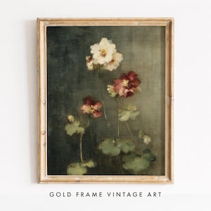 May include: A framed wall art print featuring a dark, textured background with a botanical illustration of white and deep red flowers. The artwork is encased in a light-colored wooden frame, showcasing delicate petals and green foliage stems.