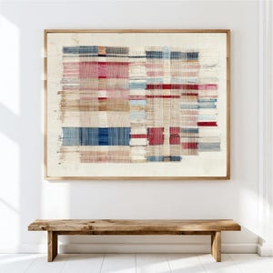 May include: A rectangular wall art piece featuring a woven textile design with a grid of horizontal and vertical threads in shades of cream, deep blue, muted red, and tan, all encased within a simple light-toned wooden frame.