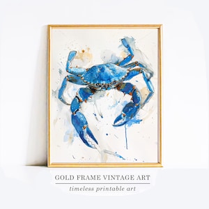 Op de afbeelding: Een ingelijste aquarelprint van een blauwe krab met een gouden lijst. De krab is geschilderd in blauwtinten met oranje accenten, tegen een witte achtergrond met aquarelspatten. De tekst "GOLD FRAME VINTAGE ART" en "timeless printable art" staat onderaan.