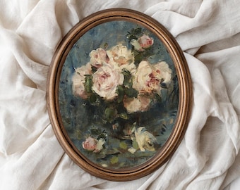 May include: Oval framed painting of a bouquet of light pink roses with green leaves against a blue background. The wooden frame has a warm, brown tone. The artwork is set against a backdrop of a white, textured fabric.