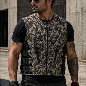 Male rider wearing a digital camouflage motorcycle vest with zip pockets and adjustable black side straps.