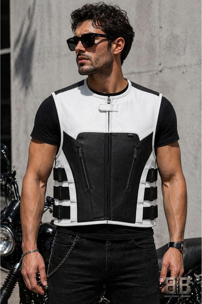 Male rider wearing a white and black leather motorcycle vest with zip pockets, center zipper and adjustable side straps.