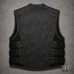 Back view of a black tactical biker vest with green contrast stitching, a solid leather back panel and three adjustable side straps.
