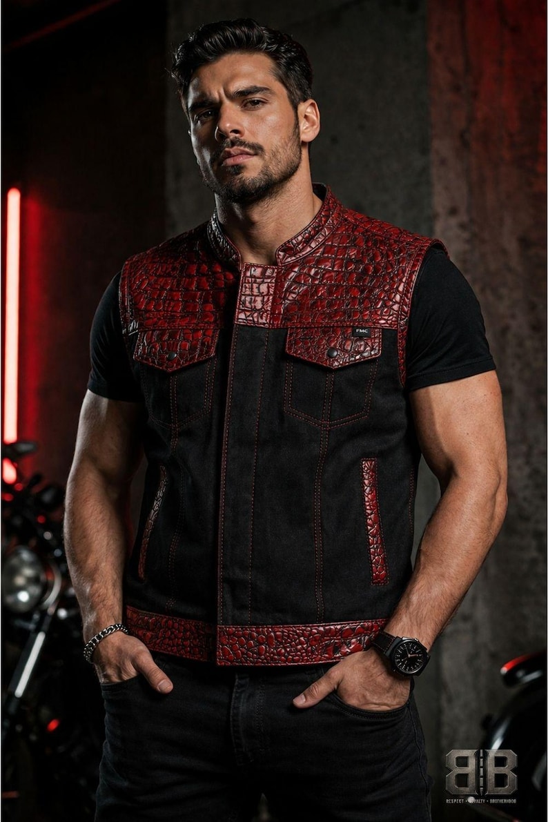 Male rider wearing a black motorcycle vest with glossy red croc-textured panels, chest pockets and red contrast stitching.