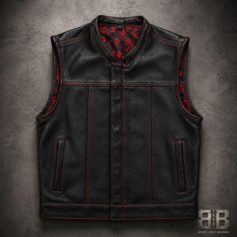 Front view of a black biker vest with red contrast stitching, two vertical pockets and a red patterned inner lining.