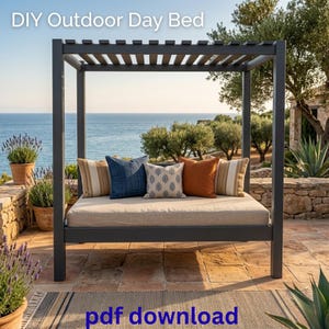 May include: A dark gray wooden outdoor day bed with a slatted canopy roof and a beige mattress. The bed features four decorative throw pillows in blue, orange, and striped patterns. The text "DIY Outdoor Day Bed" and "pdf download" are visible.