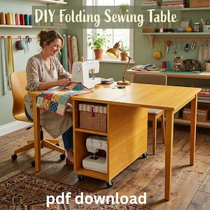 May include: A light-coloured wooden folding sewing table with a built-in storage unit featuring two open shelves. The top shelf holds a striped storage box, and the bottom shelf contains a white sewing machine. The table is on casters.
