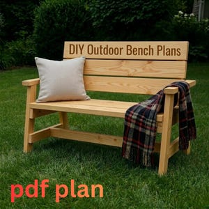 May include: A wooden outdoor bench with a light-colored finish, featuring armrests and a backrest. A beige pillow rests on the seat, and a plaid blanket is draped over the arm. The text "DIY Outdoor Bench Plans" is visible on the backrest, and "pdf plan" is at the bottom.