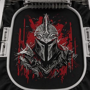 May include: Black fabric with a detailed embroidered design of a warrior helmet in shades of gray and red. The helmet has a pointed top and intricate detailing. The embroidery is being done by a machine.