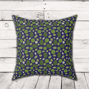 May include: A blue throw pillow with a green and white polka dot pattern.