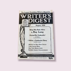 May include: A black and white magazine cover for Writer's Digest, August 1932. The cover features a quill pen and inkwell, and the text "Bring Him Back Alive by Ray Long" and "Praised Be Cinderella!"  The magazine is described as "The National Literary Business Magazine".