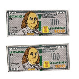 May include: Two embroidered patches in the shape of a $100 bill. The patches feature a portrait of Benjamin Franklin, with text that reads "100" and "The United States of America". The patches are gray, green, yellow, and brown.