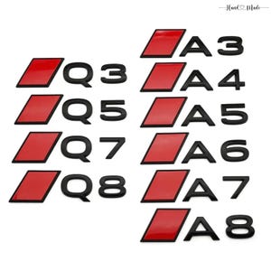 May include: A collection of black car emblems, including A3, A4, A5, A6, A7, A8, Q3, Q5, Q7, and Q8. Each emblem features a red rectangular accent. The words "Hand Made" are in the top right corner.