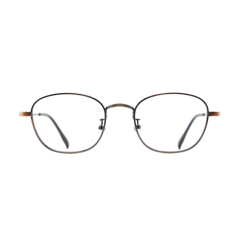 May include: Eyeglasses with a thin, dark brown metal frame and clear lenses. The round lenses are surrounded by a thin, dark frame with a subtle pattern. The temples have a gold-coloured accent.