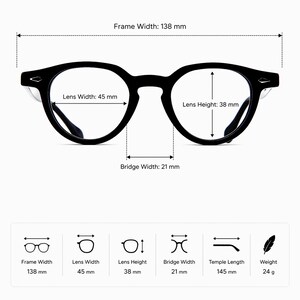 May include: Black round-frame eyeglasses with measurements: frame width 138 mm, lens width 45 mm, lens height 38 mm, bridge width 21 mm, temple length 145 mm, and weight 24 g. The glasses have a classic design.