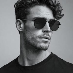 May include: Black metal aviator sunglasses with a thin double bridge and dark tinted lenses. The frame features a square-shaped silhouette with rounded edges, thin temples, and adjustable nose pads, providing a sleek and functional eyewear design.